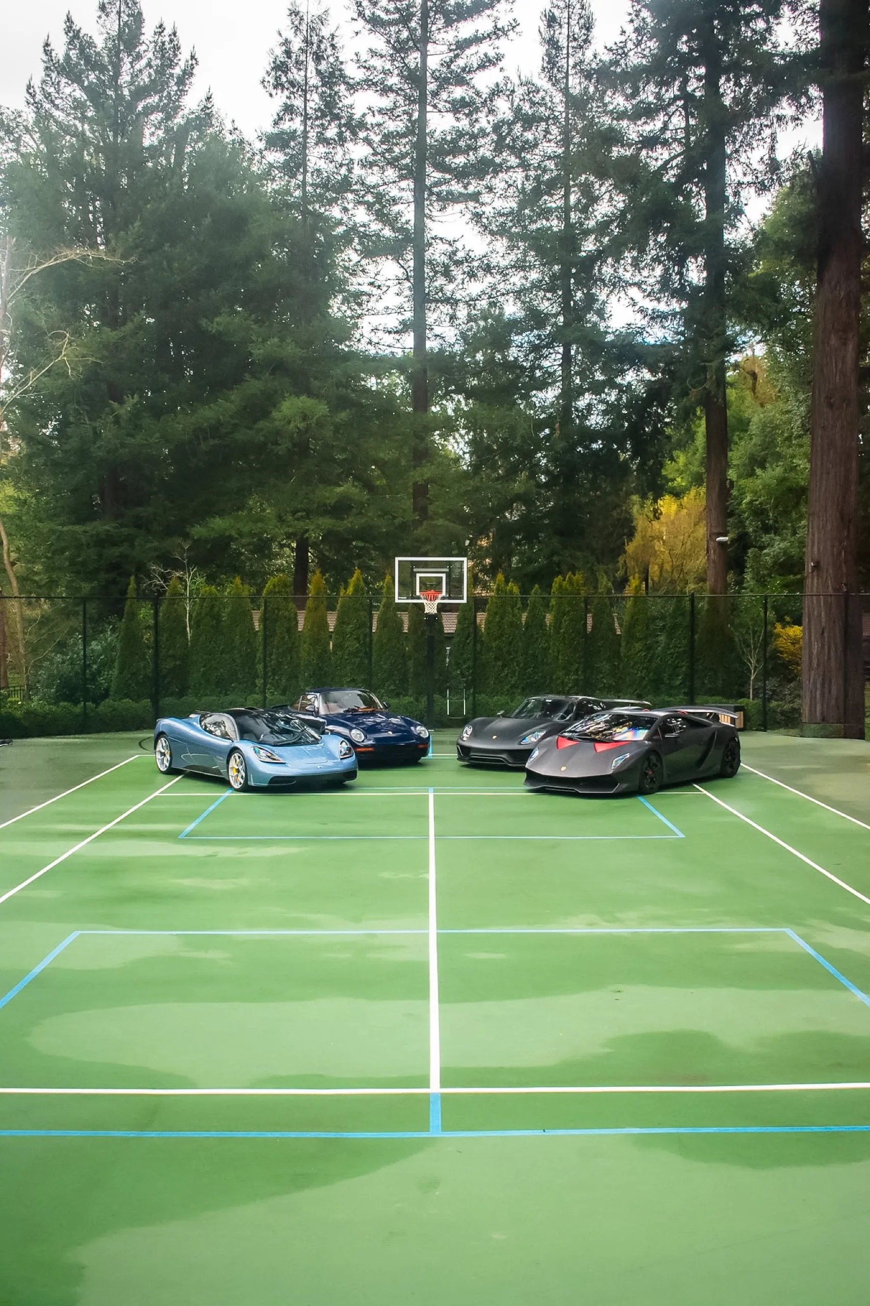 Dark green and orange Pagani Huayra Roadster BC in front of the Nearest Green Distillery