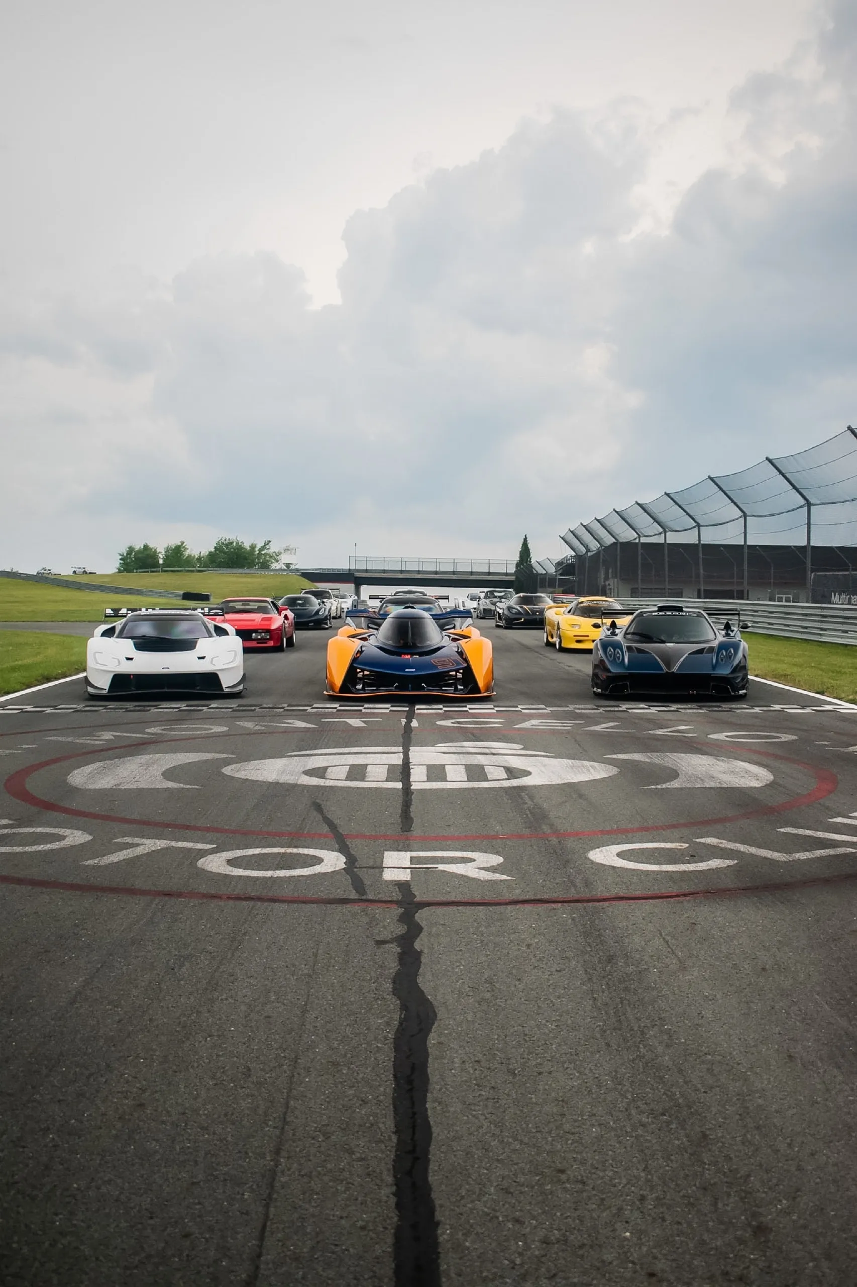 Nine hypercars lined up over the Monticello Motor Club logo