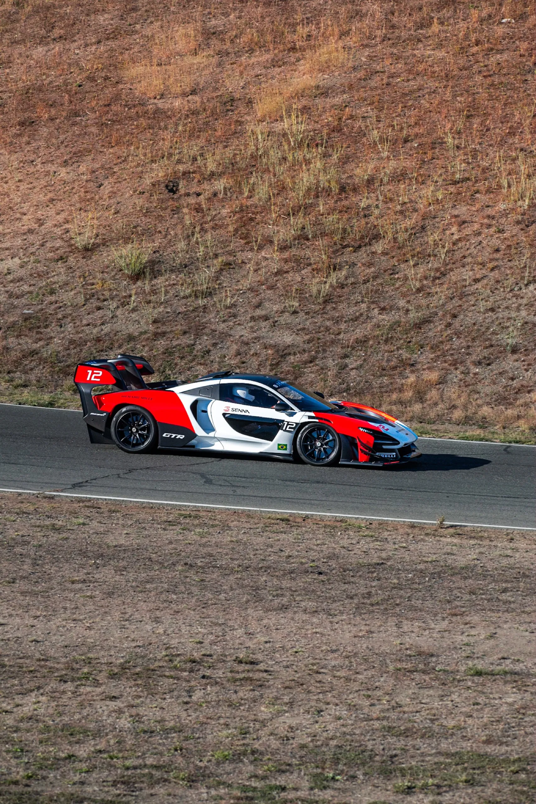 McLaren Senna GTR #12 in red, white and black “SENNA” livery, at speed on track