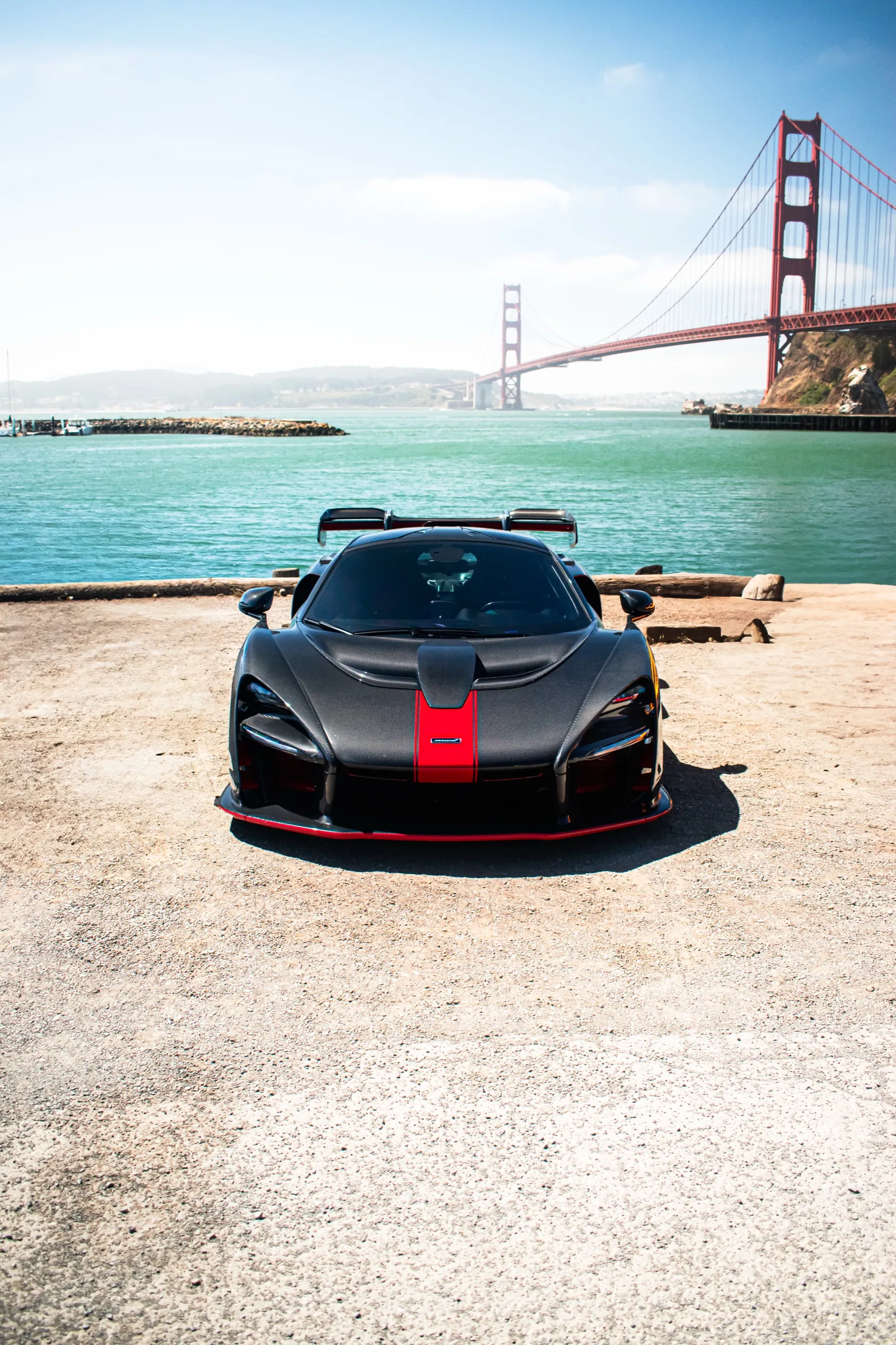 White Pagani Huayra BC with blue accents, in front of the Golden Gate Bridge
